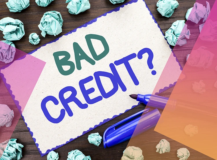A paper sign on the desktop saying: Bad Credit?